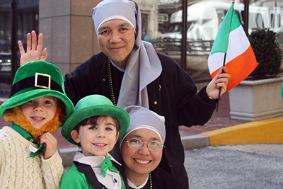 The Little Nursing Sisters of the Sick Poor kept their traditional dress. Here two sisters enjoy the St. Patrick's Day Parade in New York in 2013.