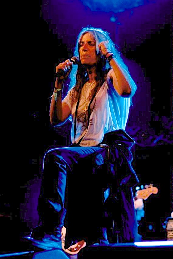 Patti Smith performing at a concert which the main character attends.