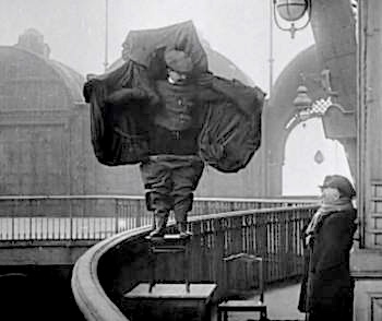 When the speaker is unable to take the action he wants to take, he thinks of Franz Reichelt, the Flying Tailor, who in 1912, decided to test a parachute he'd developed. After a long wait to draw courage, he jumped to his death from the Eiffel Tower.
