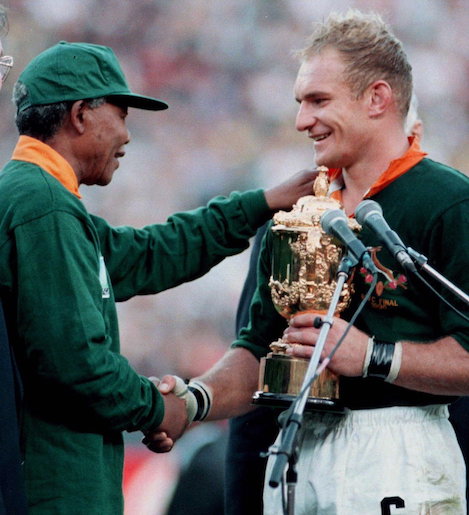 President Nelson Mandela congratulates S. Afr. Capt. Francois Pienaar for the team's win of the World Cup for rugby in 1995.