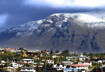 Flat-topped Mt. Esja dominates the skyline over Reykjavik, as Erlendur points out.