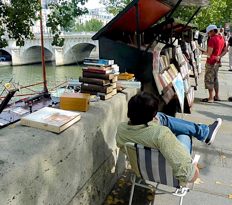 Among Les Bouquinistes, booksellers, on the left bank at the Quay de la Tournelle, the speaker finds three books by Fred Bouviere, a guru popular among students at the time.